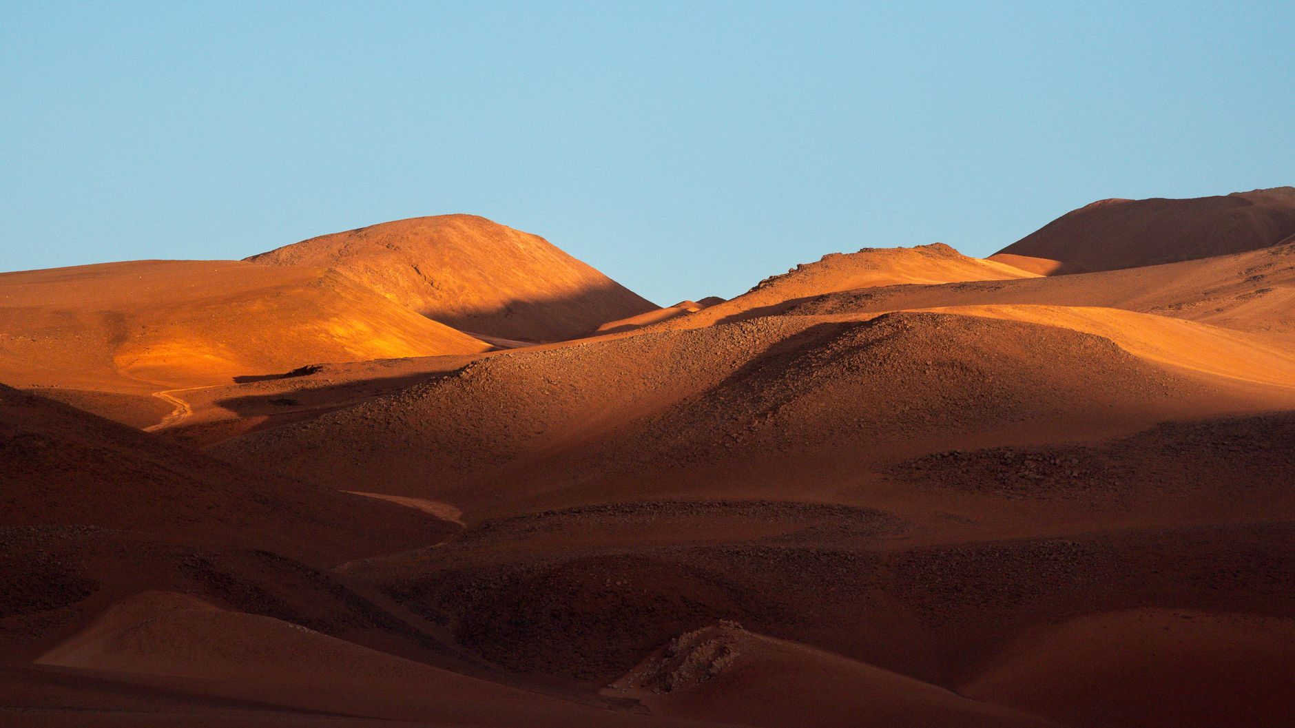 Arid desert dunes and salt flats in Atacama
